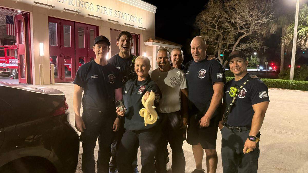 La pitón bola, Ritchie, de nuevo en manos de su dueña después de que los bomberos de Coral Springs, Florida, la rescataron.