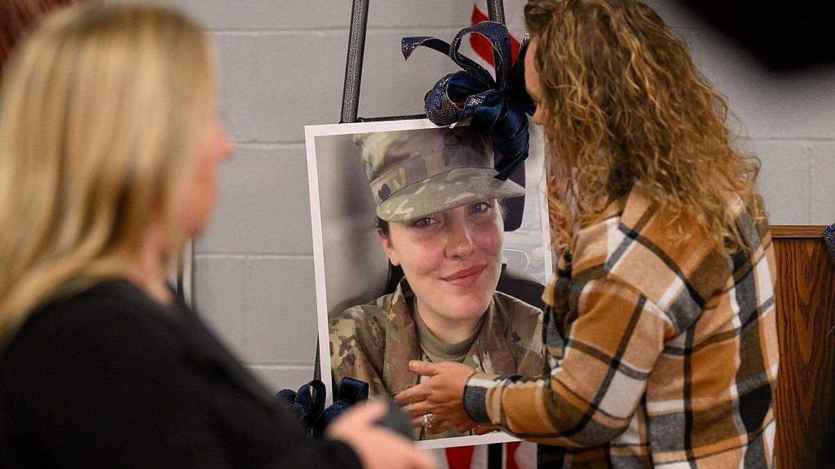 WEBSTER SPRINGS, WEST VIRGINIA - NOVEMBER 28: Community members prepare a portrait of West Virginia National Guard Specialist Sarah Beckstrom for a vigil in her honor at the town hall on November 28, 2025 in Webster Springs, West Virginia. Beckstrom was one of two West Virginia Guardsmen attacked while guarding Washington, DC.(Photo by Jeff Swensen/Getty Images)