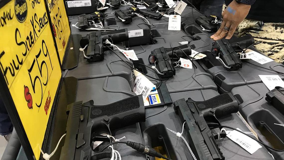 A table of firearms at the Florida Gun Show in Tampa, Fla. 