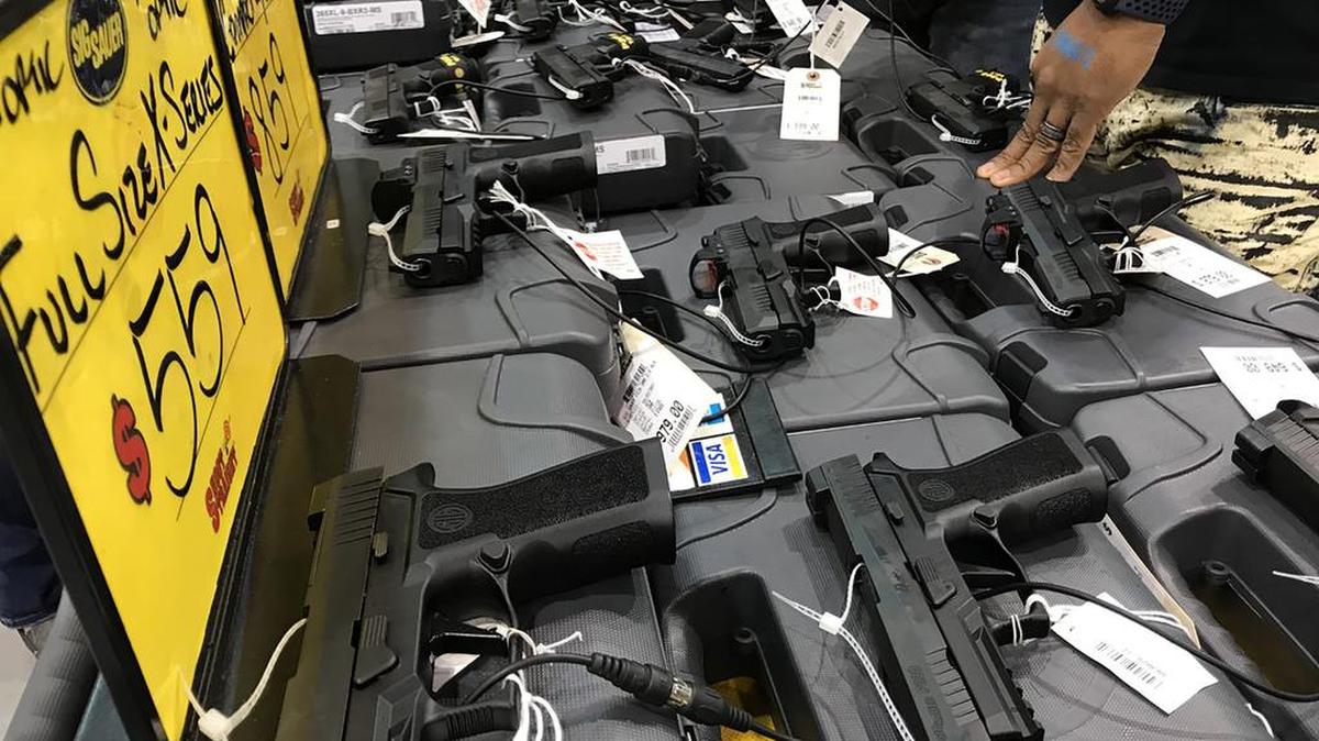 A table of firearms at the Florida Gun Show in Tampa, Fla.