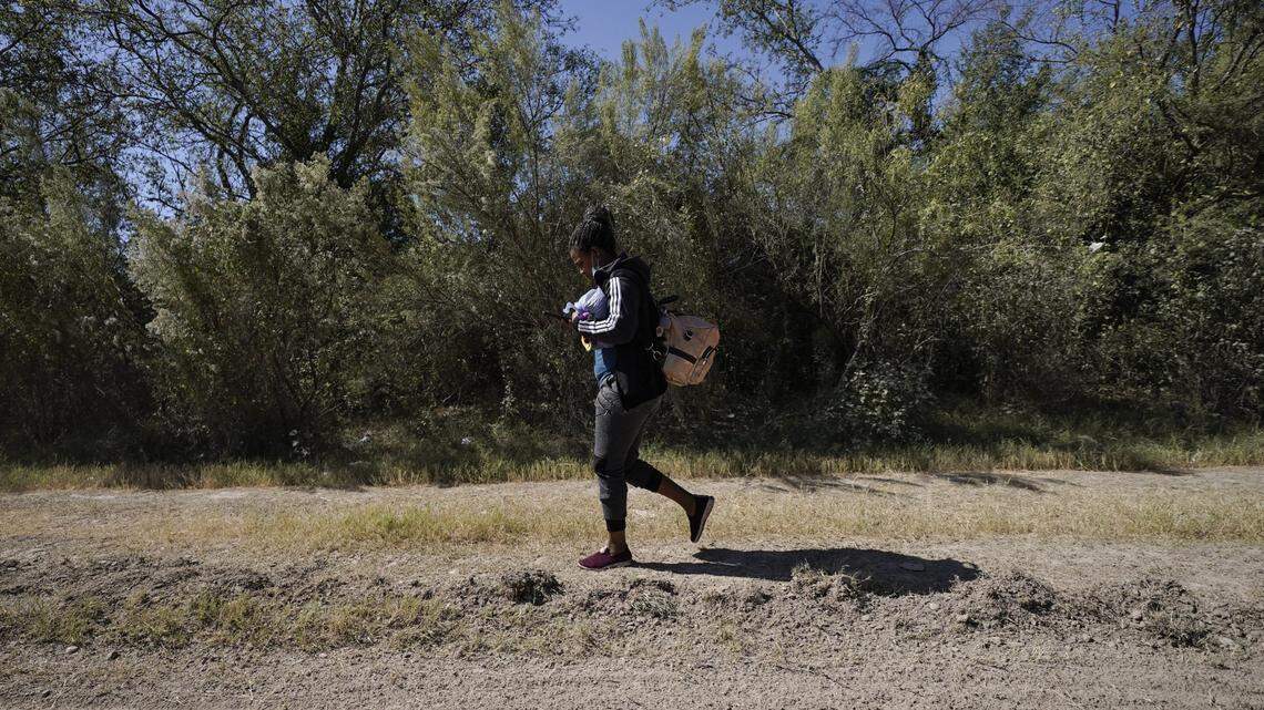A Cuban citizen walks down a highway after crossing the Texas-Mexico border at the Rio Grande River on September 23, 2021.