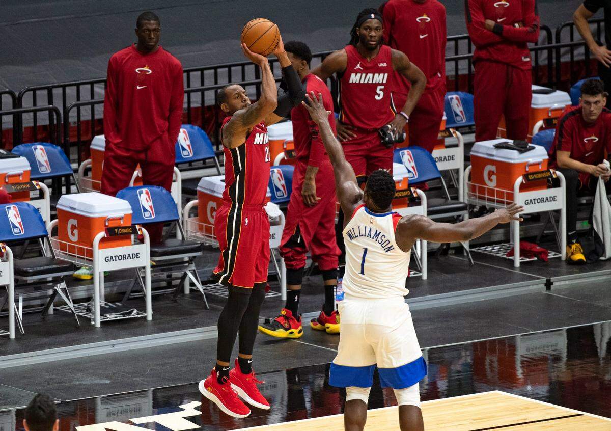 Miami Heat guard Andre Iguodala (28) hits a three-pointer against New Orleans Pelicans forward Zion Williamson (1) in the first quarter of a NBA basketball game on Christmas Day at the AmericanAirlines Arena on Friday, December 25, 2020.