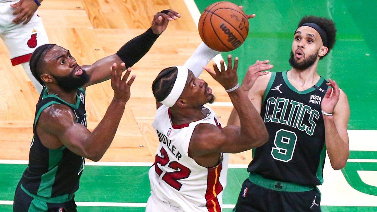 Miami Heat forward Jimmy Butler (22) battles for the ball as Boston Celtics guard Jaylen Brown (7) and guard Derrick White (9) defend during the second quarter of Game 6 of the NBA Eastern Conference Finals series at TD Garden in Boston, Massachusetts, on Friday, May 27, 2022
