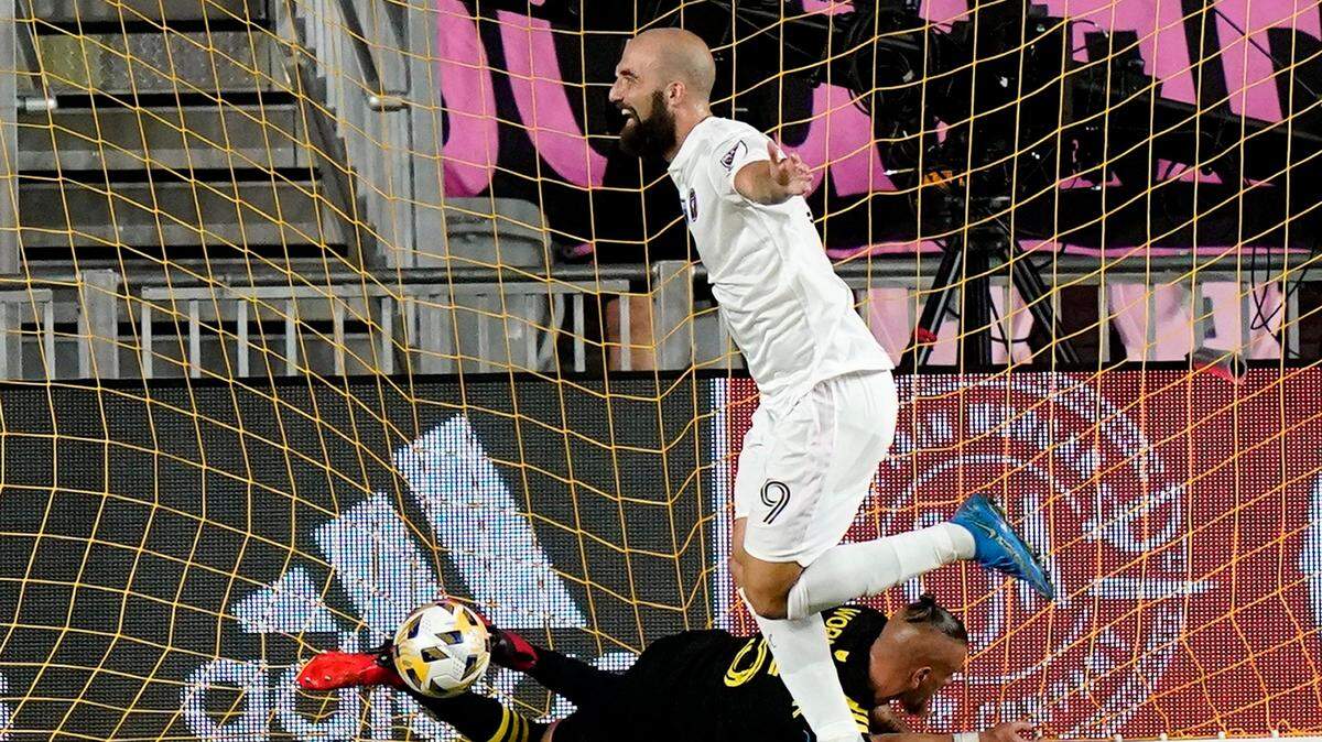 Inter Miami forward Gonzalo Higuain (9) celebrates after scoring a goal as Columbus Crew defender Vito Wormgoor falls to the field during the first half of an MLS soccer match Saturday, Sept. 11, 2021, in Fort Lauderdale, Fla. (AP Photo/Lynne Sladky)