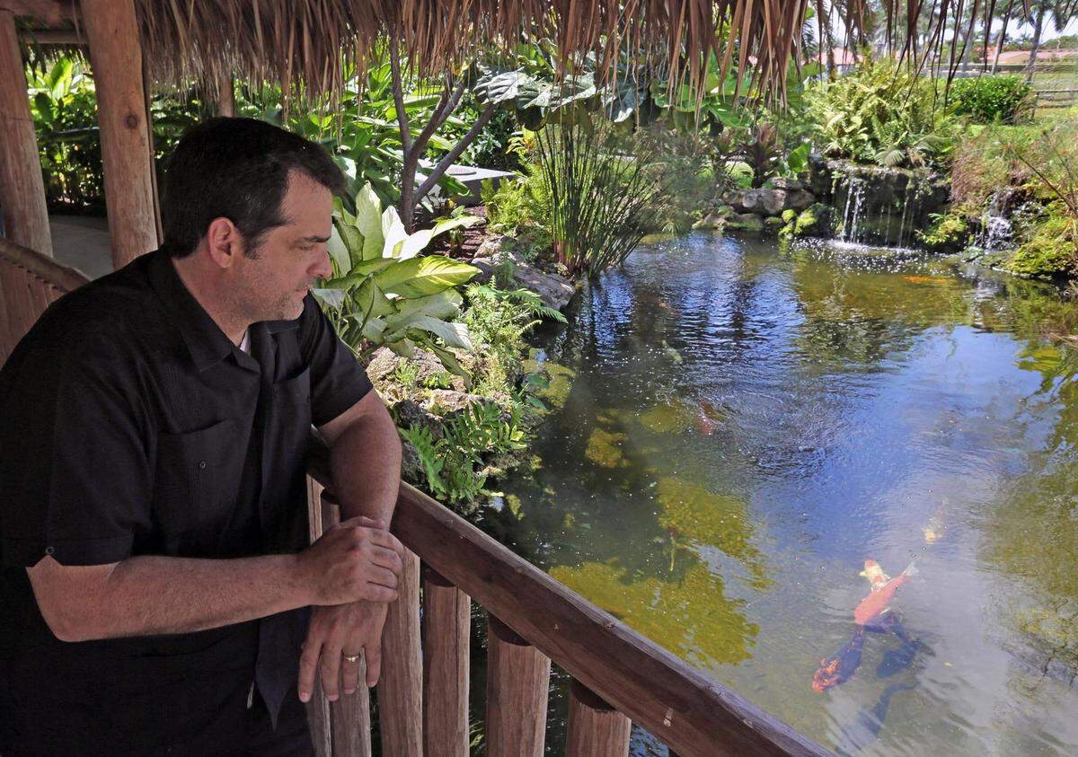 Hialeah Gardens Mayor Yionet De La Cruz observes the fish in the pond at the  Botanical Gardens in Hialeah Gardens.