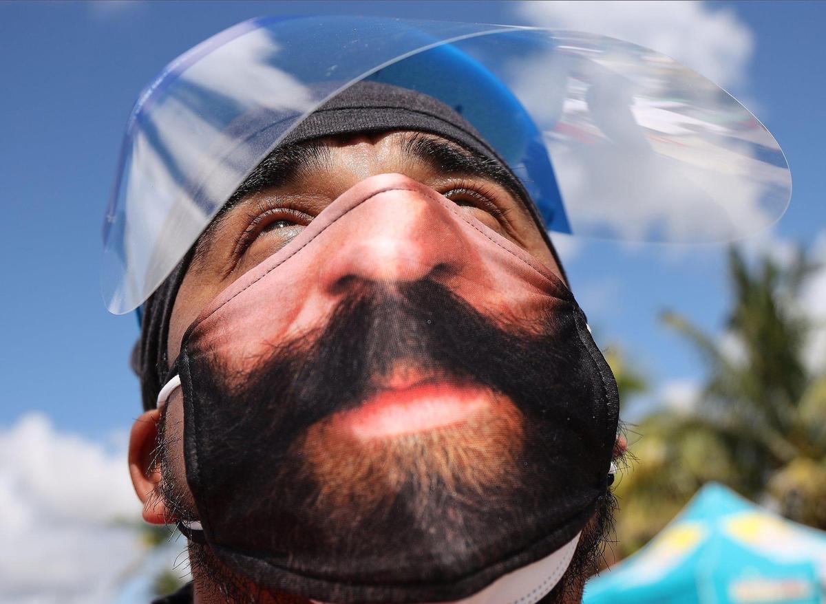 Fernando Figueroa wears his distinctive mask as he volunteers in food distribution as about 100 tests were administered and 100 boxes of food were distributed in order to engage the migrant community in COVID-19 testing and dispelling COVID-19 rumors on Sunday, August 30, 2020 in Miami-Dade’s agricultural neighborhood in Redland.
