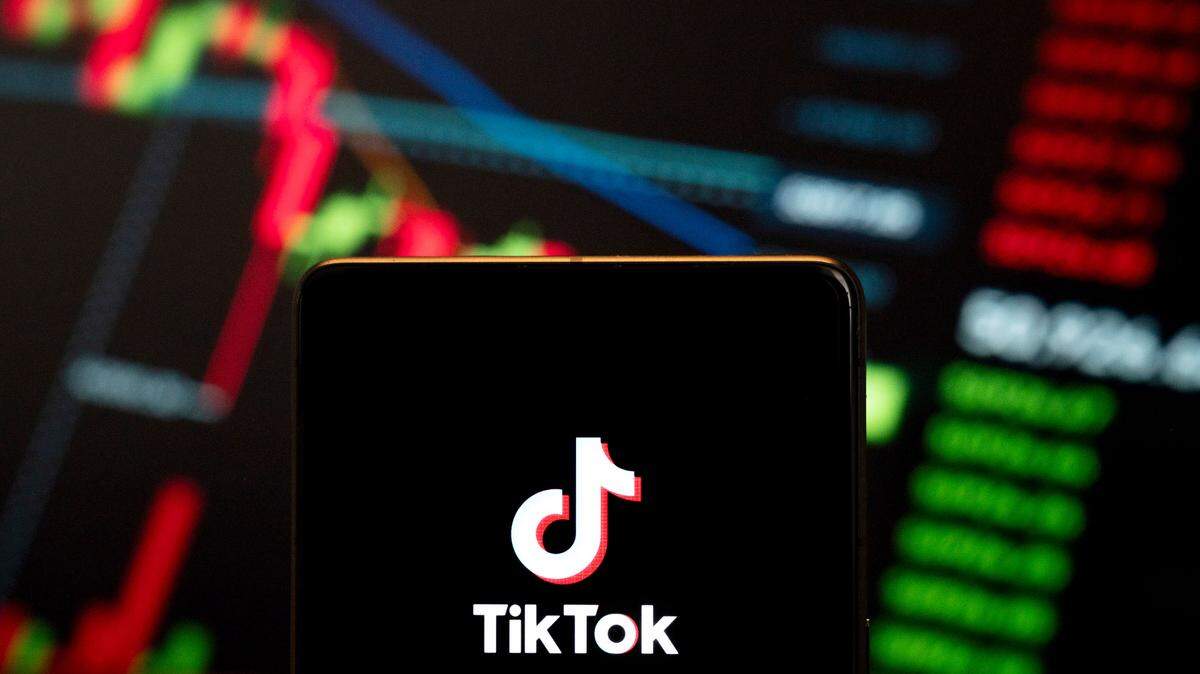 In this photo illustration, the Chinese video-sharing social networking service company TikTok logo seen displayed on a smartphone with an economic stock exchange index graph in the background. (Photo by Budrul Chukrut / SOPA Images/Sipa USA) *** Strictly for editorial news purposes only ***