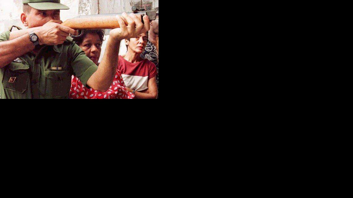 En esta foto de archivo de 1997 un soldado cubano da instruciones de cómo disparar con rifle. AFP PHOTO/Adalberto ROQUE