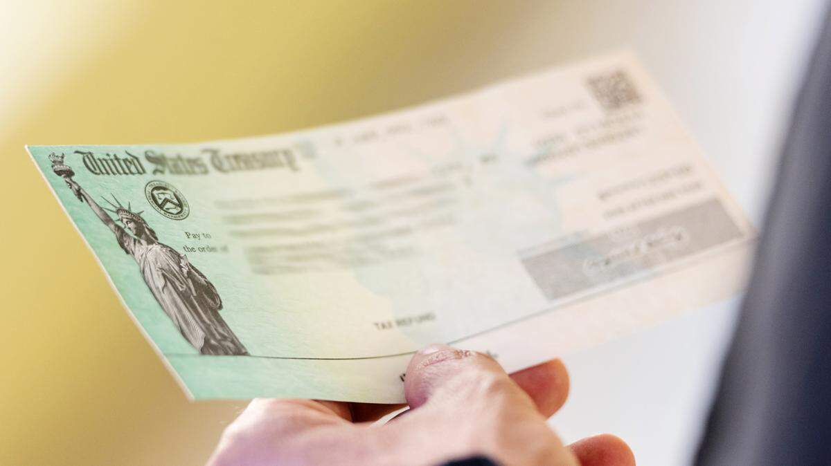 Men hands holding a US Government Treasury check