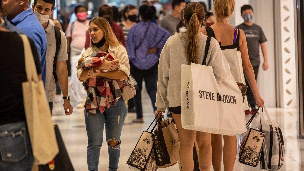 New shops and restaurants are opening all over Miami-Dade and Broward counties. Above: Shoppers walk around Aventura Mall on Black Friday, Nov. 26, 2021.