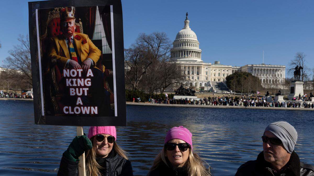 Una mujer sostiene una pancarta con una imagen del presidente Donald Trump que dice, “No es un rey sino un payaso”, durante una protesta contra las políticas del gobierno, el lunes 17 de febrero de 2025, en Washington, D.C.