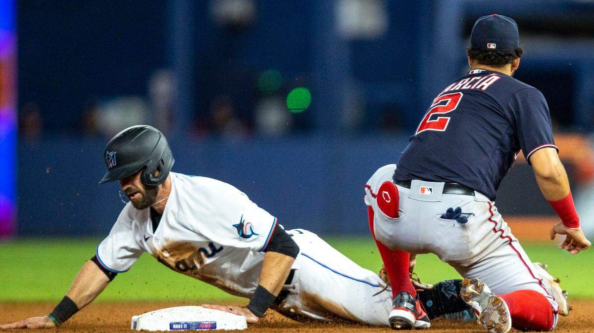 El jugador de los Marlins Jon Berti (izq.) se roba la segunda base en el noveno inning del partido ante los Nacionales de Washington, celebrado el 8 de junio de 2022 en Miami.