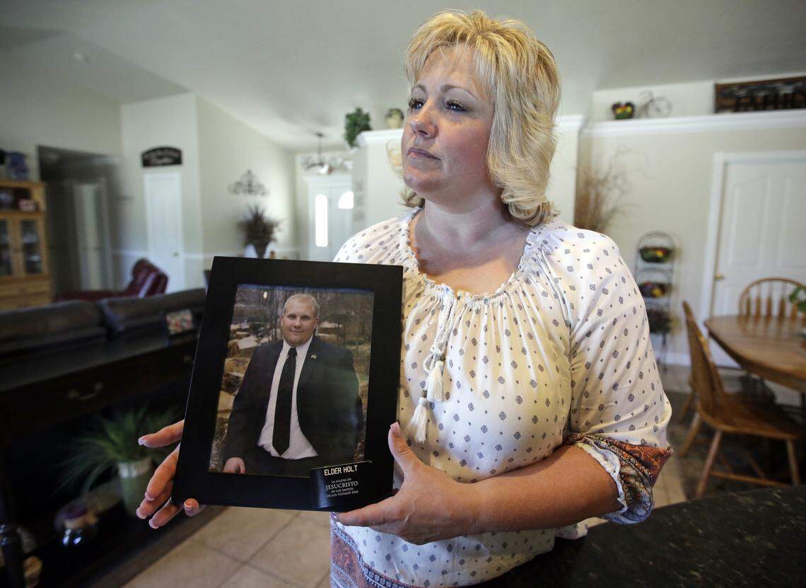 Laurie Holt holds a photograph of her son, Joshua Holt, in her home in Riverton, Utah, in July of 2016., shortly after the young man was detained in Caracas, Venezuela.