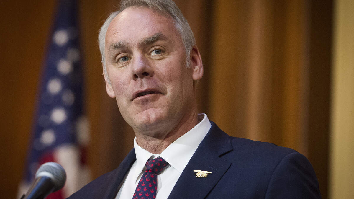 FILE - In this Dec. 11, 2018 file photo, Secretary of the Interior Ryan Zinke speaks after an order withdrawing federal protections for countless waterways and wetland was signed, at EPA headquarters in Washington. Trump says on Saturday, Dec. 15, Zinke leaving administration at end of year, successor to be announced next week.(AP Photo/Cliff Owen)