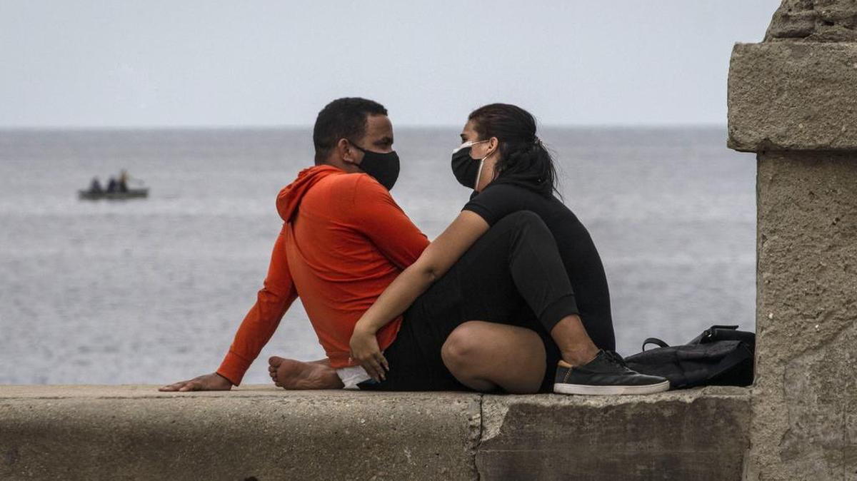 Una pareja sentada en el muro del malecón en La Habana, Cuba, el viernes 5 de febrero de 2021.