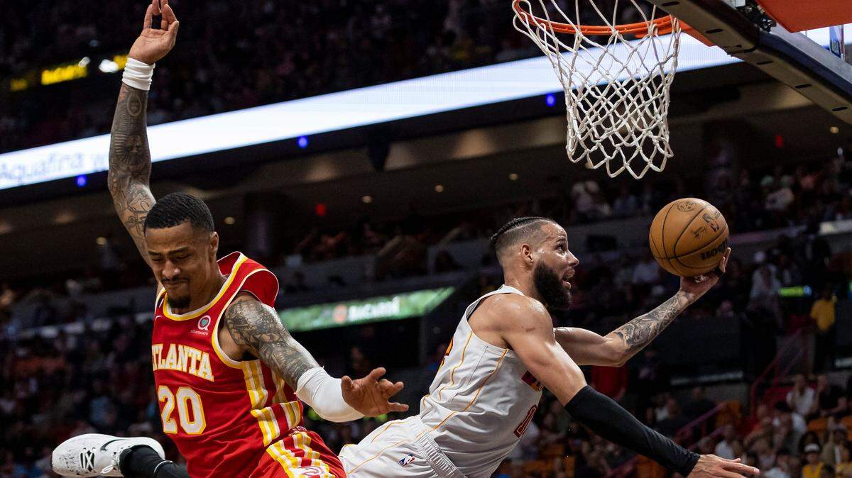 Miami Heat forward Caleb Martin (16) tries to score as Atlanta Hawks forward John Collins (20) defends during the second quarter of an NBA game at the Miami-Dade Arena on Monday, March 6, 2023, in downtown Miami, Fla.