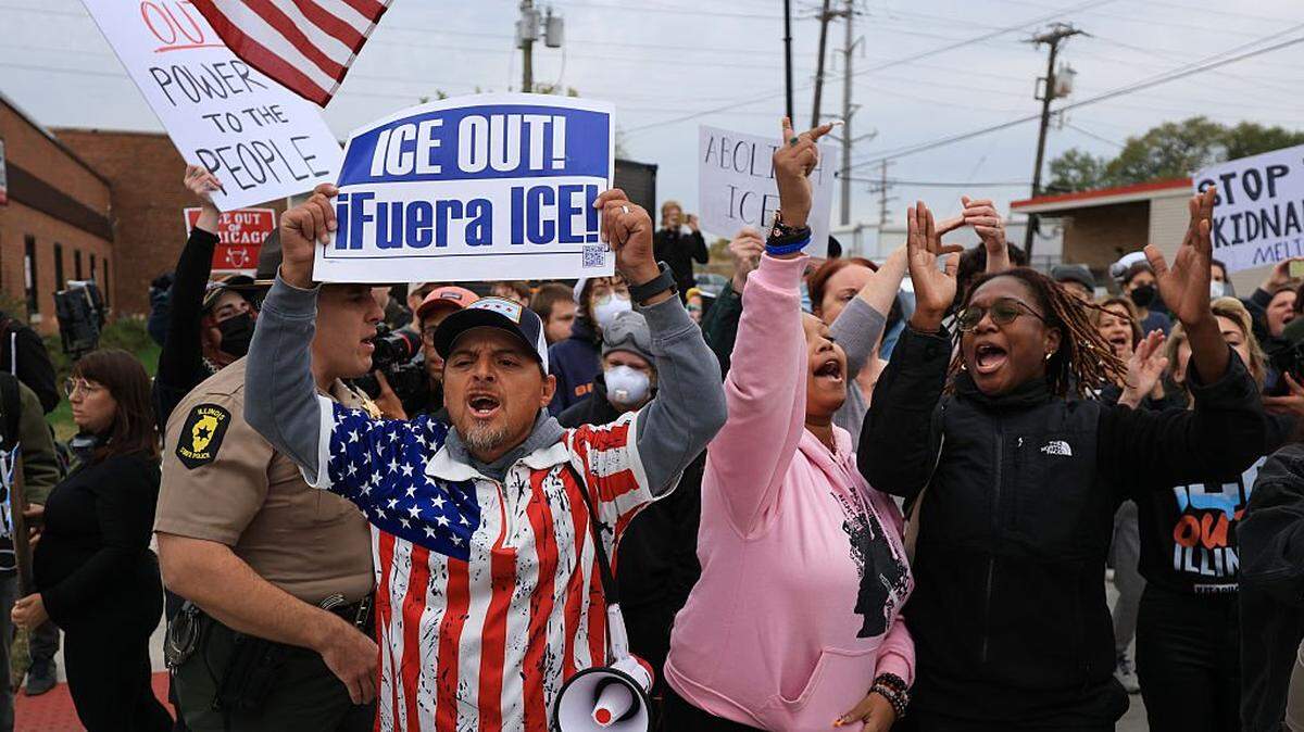 BROADVIEW, ILLINOIS - OCTOBER 17: Demonstrators make themselves heard outside of the "Free Speech Zone" near the immigrant processing and detention center on October 17, 2025 in Broadview, Illinois. Demonstrations have been taking place outside of the facility for several weeks as the Trump administration's Operation Midway Blitz has been underway, arresting and detaining immigrants in the Chicago area. (Photo by Joe Raedle/Getty Images)