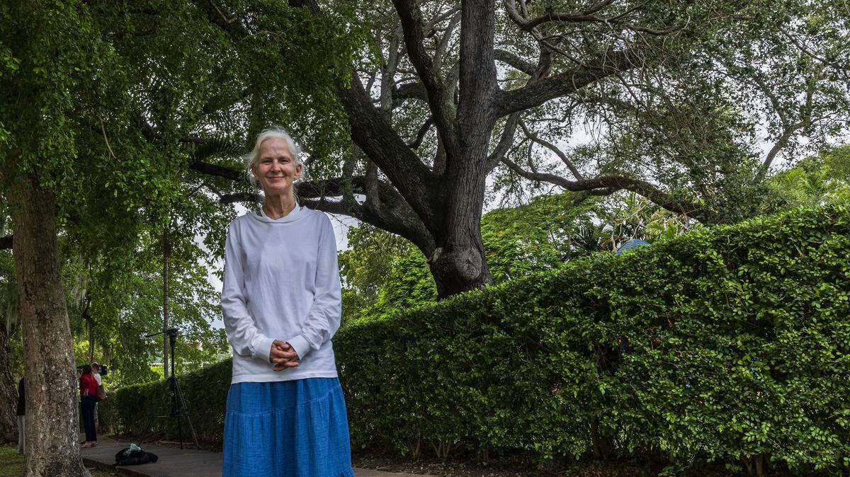Bonnie Bolton posa frente a un roble centenario que crece dentro de Crystal Academy, en Coral Gables. El roble peligra ante un gran proyecto de urbanización.