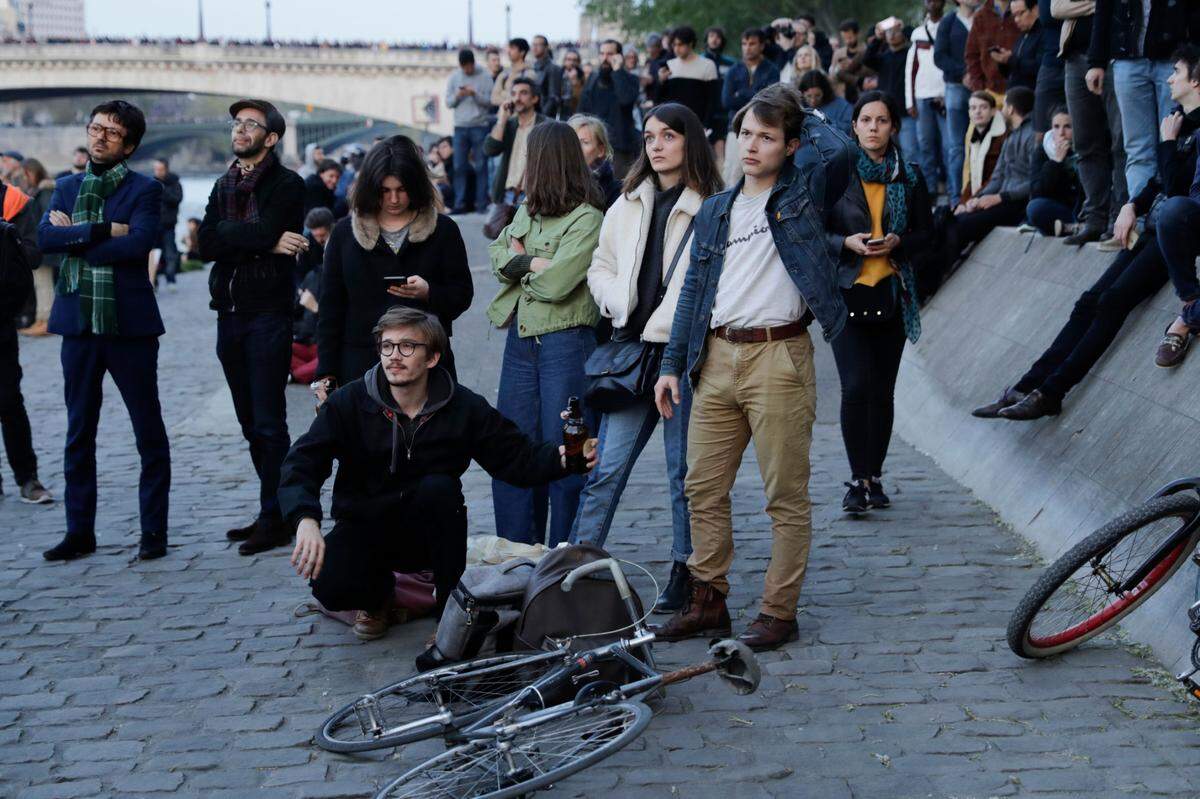 People look at smoke and flames rising during a fire at the landmark Notre-Dame Cathedral in central Paris on April 15, 2019. - A fire broke out at the landmark Notre-Dame Cathedral in central Paris, potentially involving renovation works being carried out at the site, the fire service said. (Photo by Thomas SAMSON / AFP)THOMAS SAMSON/AFP/Getty Images