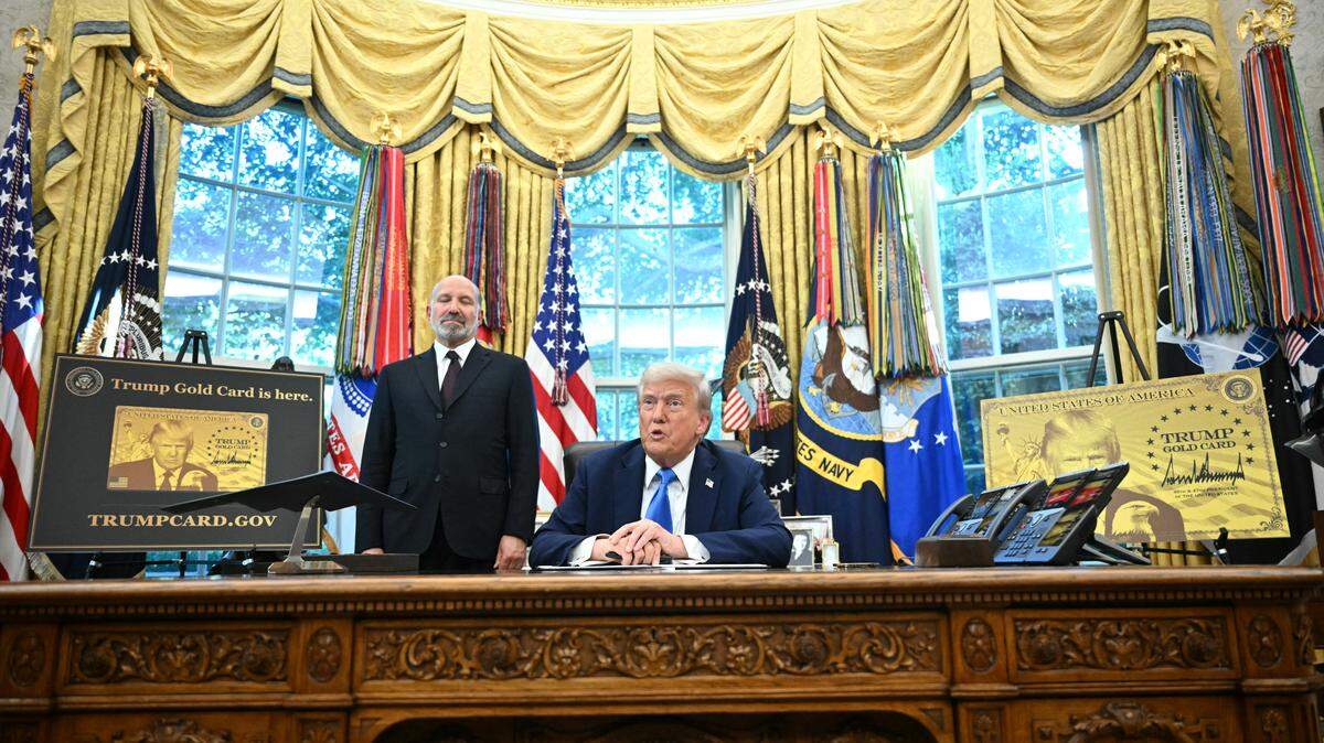 US President Donald Trump speaks before signing an executive order in the Oval Office at the White House in Washington, DC, on September 19, 2025 as Commerce Secretary Howard Lutnick (L) looks on. US President Donald Trump on Friday signed an executive order creating a "gold card" residency progam for a fee of $1 million for individuals and $2 million for sponsorships by corporations. "I think it's going to be tremendously successful," Trump told journalists. (Photo by Mandel NGAN / AFP) (Photo by MANDEL NGAN/AFP via Getty Images)