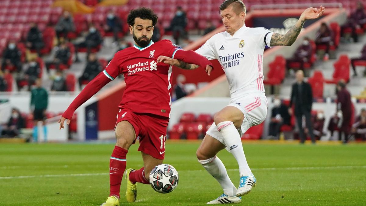 El jugador del Liverpool Mohamed Salah (izq.) conduce la pelota ante la marca de Toni Kroos, del Real Madrid, en el partido de vuelta de cuartos de final de la Liga de Campeones, celebrado el 14 de abril de 2021 en Liverpool, Inglaterra.