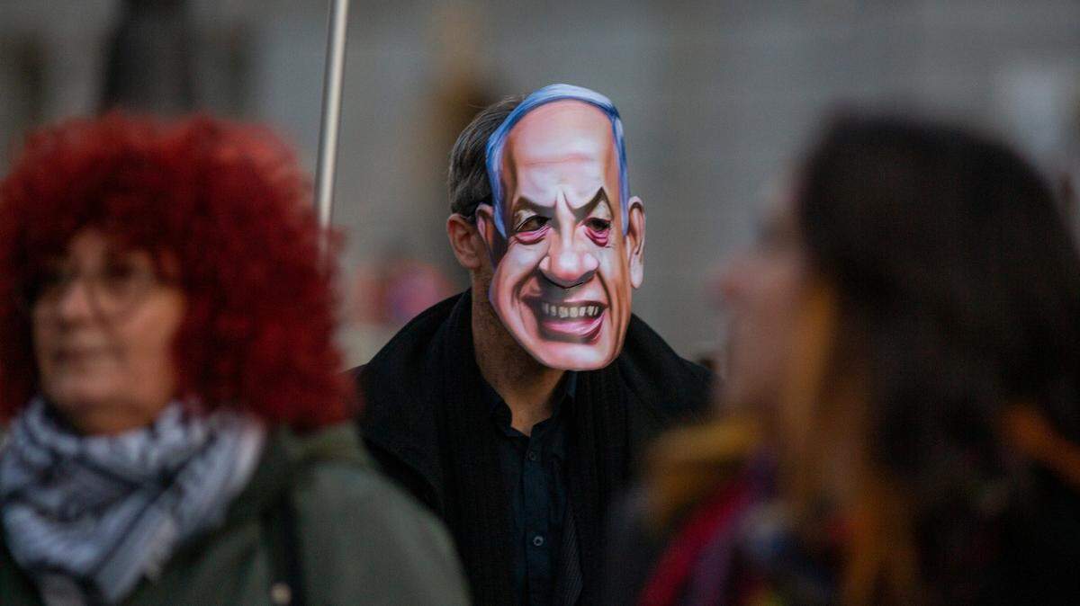 A protester wears a face-mask with the face of Israeli Prime Minister Benjamin Netanyahu, during a demonstration through the main streets of central Madrid, demanding an end to the arms trade between Spain and Israel, as well as an end to genocide in Palestine. (Photo by Luis Soto / SOPA Images/Sipa USA)
