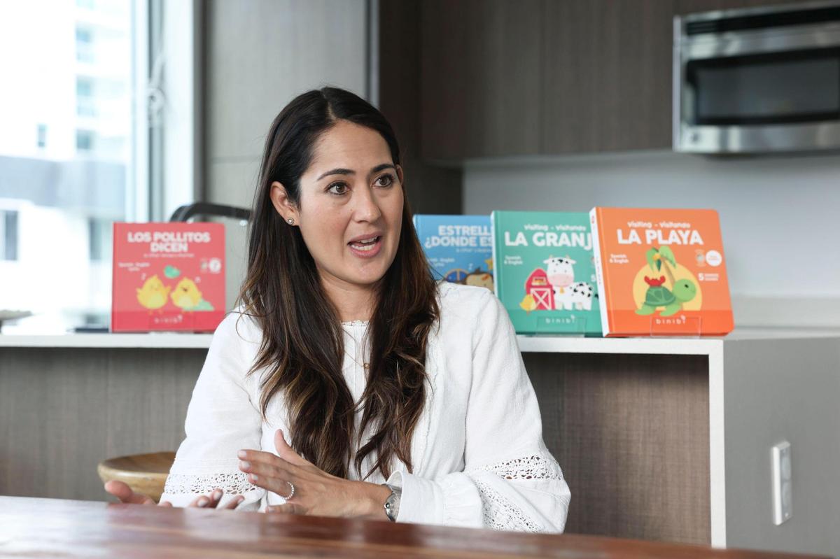 Ana Guzman talks about her new children’s books on Monday, Oct. 24, 2022, in her apartment in Brickell. Many of the books have English and Spanish words for kids.
