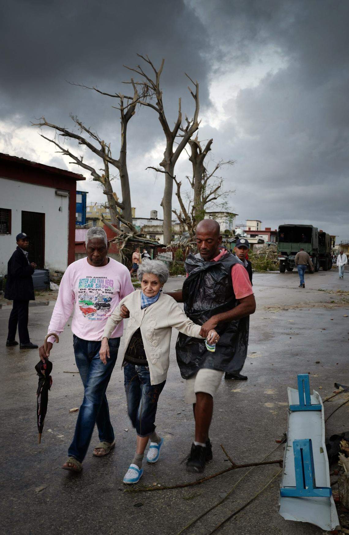 A woman receives assistance in the Regla neighborhood in the wake of a tornado that killed four people and injured 195 people.