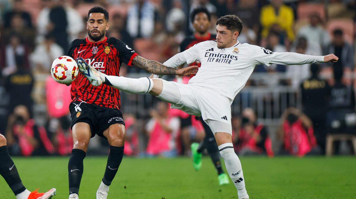El jugador del Real Madrid Fede Valverde (der.) lucha por la pelota con Omar Mascarell, de Mallorca, en el partido de semifinal de la Supercopa de España, celebrado el 9 de enero de 2025 en Yedá, Arabia Saudita.