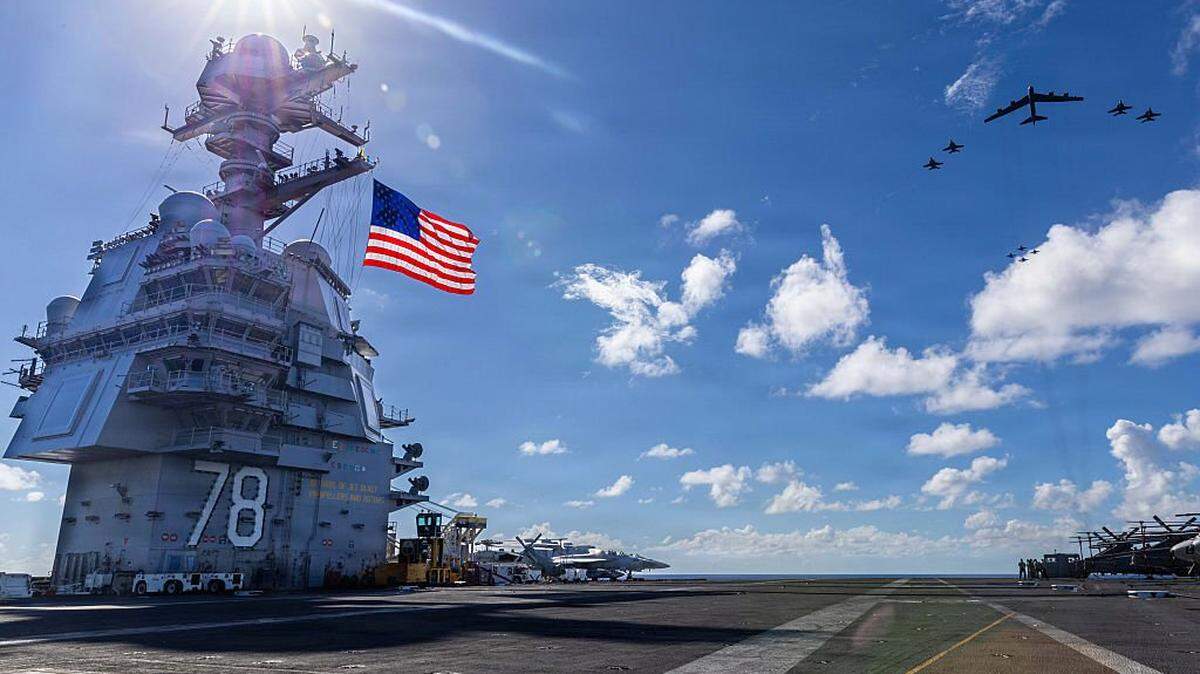 AT SEA- NOVEMBER 13: In this handout provided by the U.S. Navy, USS Gerald R. Ford (CVN 78), F/A-18E/F Super Hornets assigned to Strike Fighter Squadrons 31, 37, 87, and 213 from embarked Carrier Air Wing Eight, and a U.S. Air Force B-52 Stratofortress operate as a joint, multi-domain force, November 13, 2025. U.S. military forces, like the Gerald R. Ford Carrier Strike Group, are deployed in support of the U.S. Southern Command mission, Department of War-directed operations, and the President's priorities to disrupt illicit drug trafficking and protect the homeland. (Photo by Paige Brown/US Navy via Getty Images)