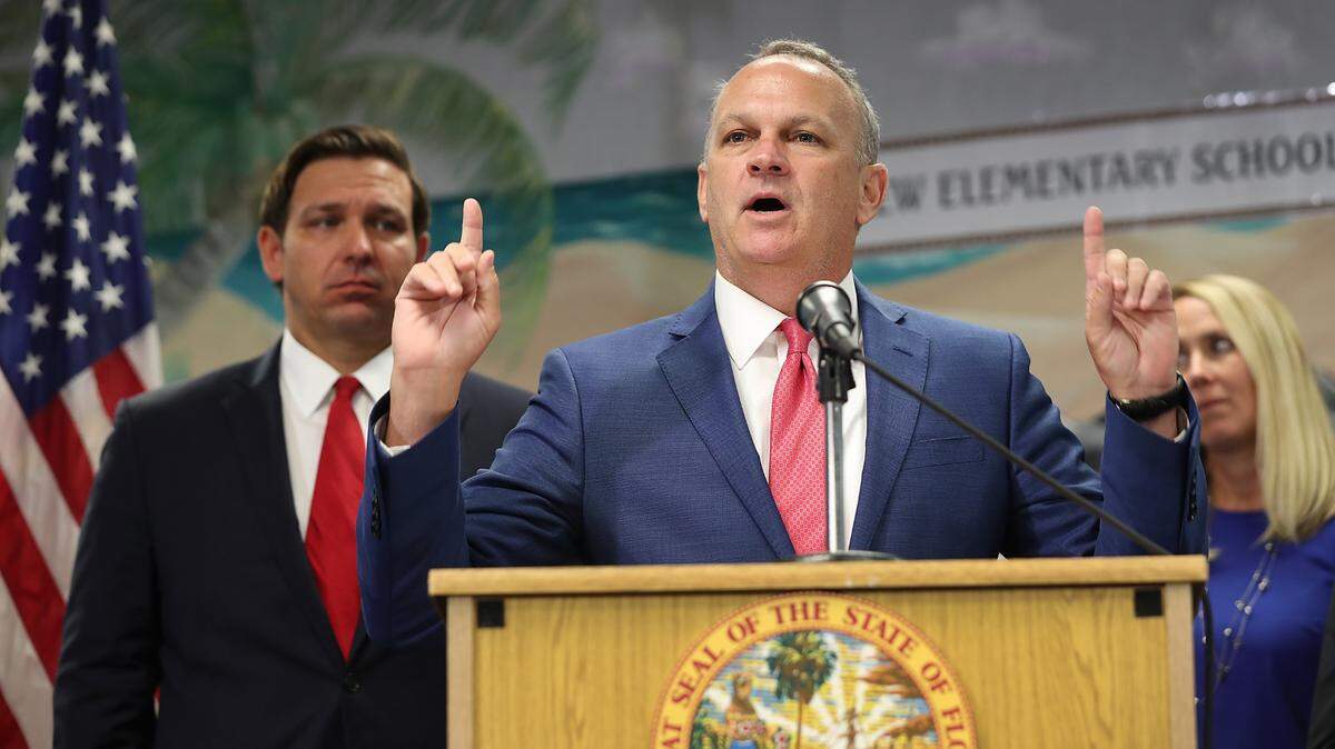 El gobernador de Florida Ron DeSantis (izq.) escucha mientras el Comisionado de Educación de Florida, Richard Corcoran, habla durante una conferencia de prensa en la Escuela Primaria Bayview en Fort Lauderdale el 7 de octubre de 2019.