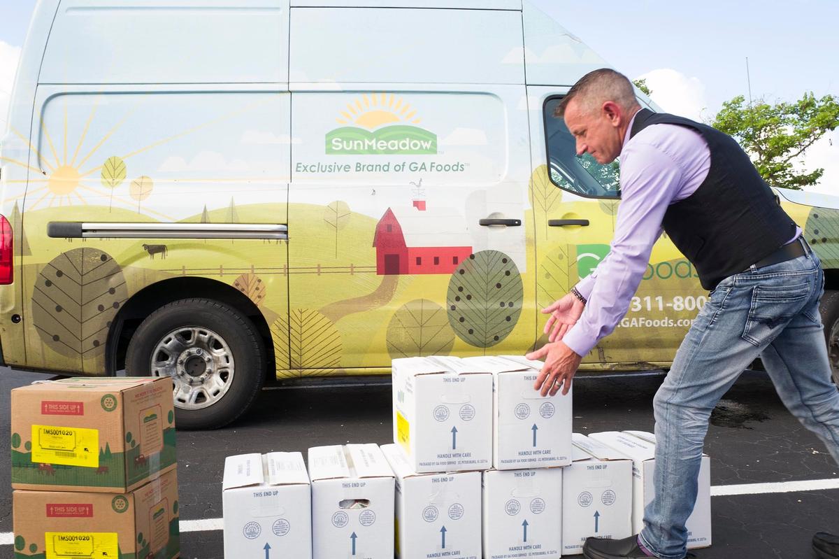 Mark Adler, executive director of Meals on Wheels, helps with food distribution as part of a program to aid the elderly population.