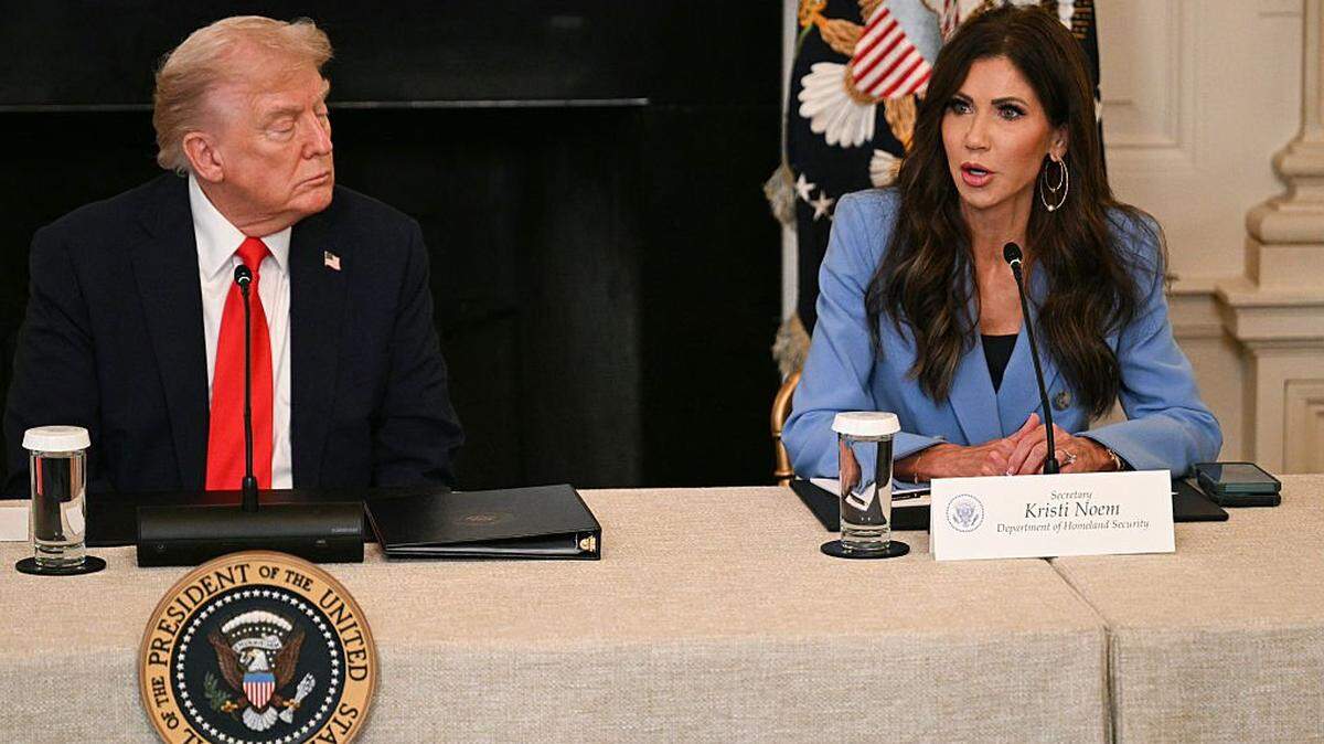 US President Donald Trump listens to Homeland Security Secretary Kristi Noem during a roundtable about Antifa in the State Dining Room of the White House in Washington, DC, on October 8, 2025. (Photo by Jim WATSON / AFP) (Photo by JIM WATSON/AFP via Getty Images)