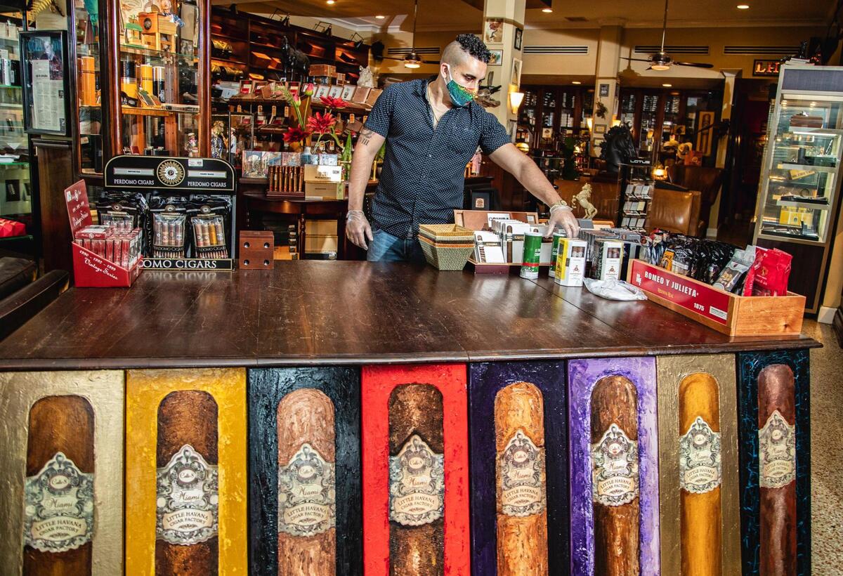 Eduardo Gigato organiza mercancías en Little Havana Cigar Factory, en la Calle Ocho, en la Pequeña Habana, en mayo.