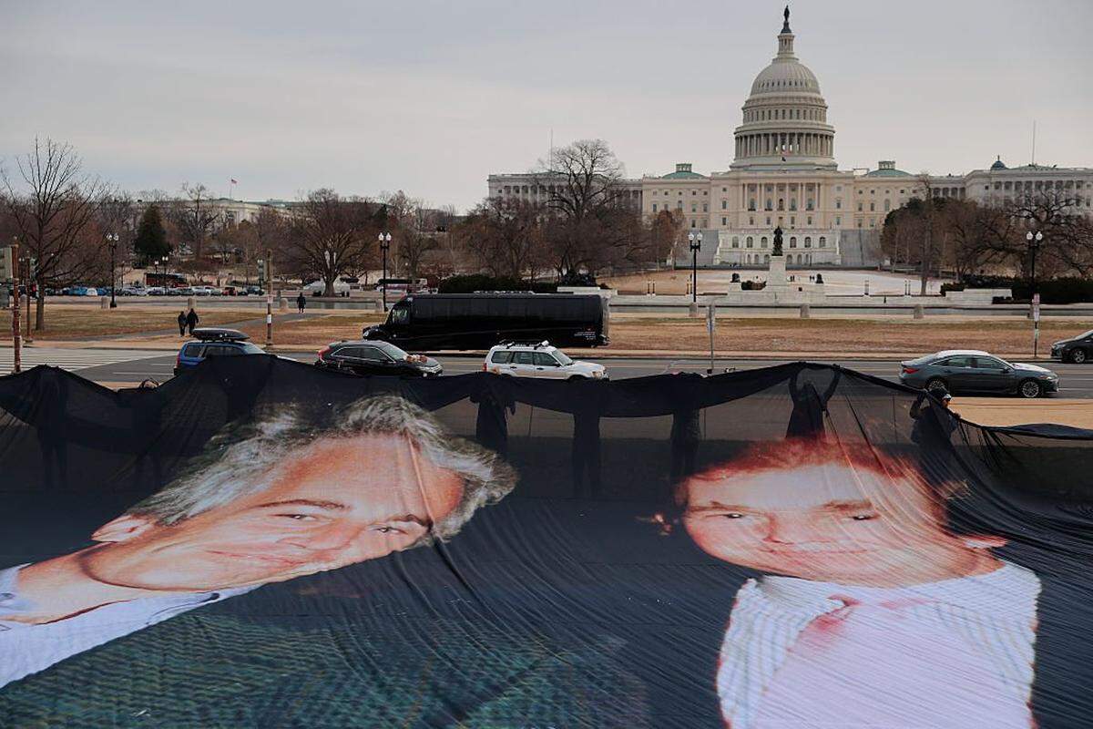 WASHINGTON, DC - DECEMBER 15: A photo of President Donald Trump and convicted sex offender Jeffrey Epstein is unfurled on the National Mall near the U.S. Capitol by the political protest organizations Everyone Hates Elon and Glasgow Actions Team on December 15, 2025 in Washington, DC. The U.S. Department of Justice is required by the Epstein Files Transparency Act to release files related to Epstein on December 19. (Photo by Heather Diehl/Getty Images)