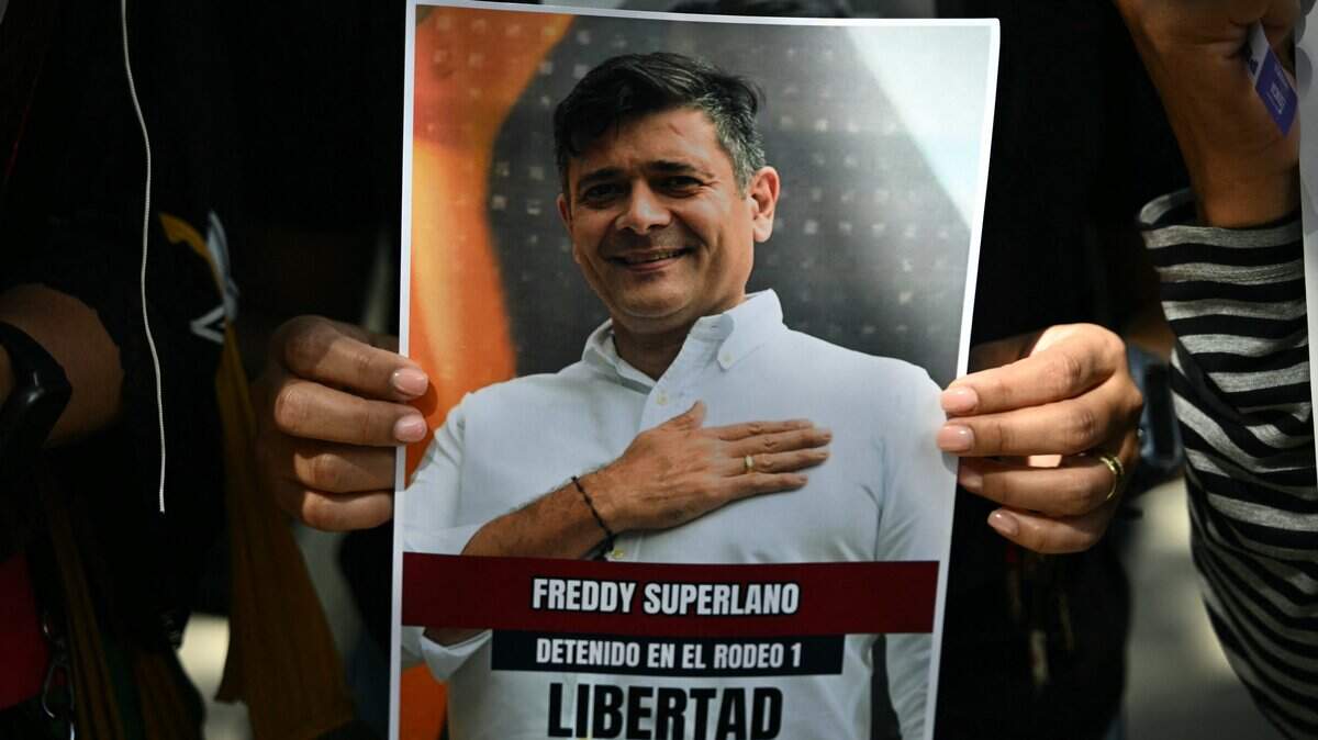 A demonstrator holds a photo of imprisoned Venezuelan opposition politician Freddy Superlano Salinas as relatives of political prisoners protest in front of the public prosecutor's office in Caracas on January 20, 2026. Dozens of journalists, government critics and activists have been freed in Venezuela since the US military deposed Nicolas Maduro this month. Rights group Foro Penal counts 90 political prisoner releases since January 8, while interim president Delcy Rodriguez says 406 people have been freed since December. Several prominent opposition figures, however, remain jailed despite US pressure (Photo by RONALDO SCHEMIDT / AFP via Getty Images)