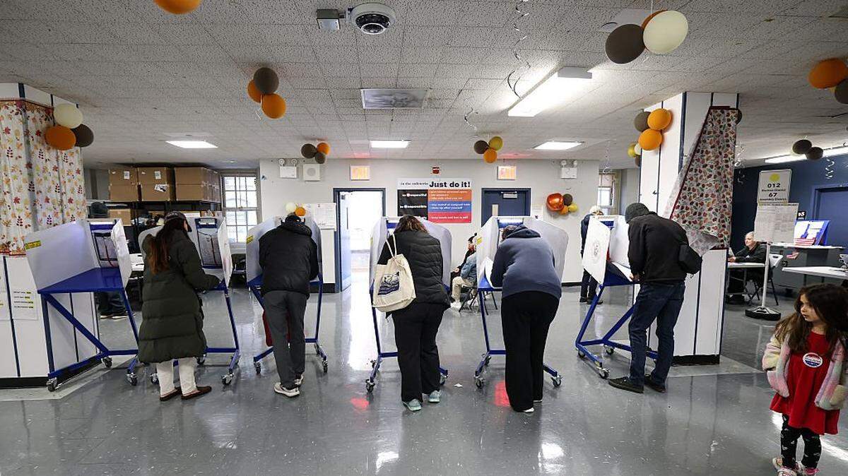 People vote at a polling location in New York City on November 4, 2025. New Yorkers will pick a new mayor on November 4 after an unpredictable race that has drawn attention from far beyond the largest city in the United States, with President Donald Trump branding frontrunner Zohran Mamdani "a communist." Breakout Democratic Party candidate Mamdani, a naturalized Muslim American who represents Queens in the state legislature, leads former governor and sex assault-accused Andrew Cuomo, running as an independent after losing his party's primary contest to Mamdani. (Photo by TIMOTHY A.CLARY / AFP) (Photo by TIMOTHY A.CLARY/AFP via Getty Images)