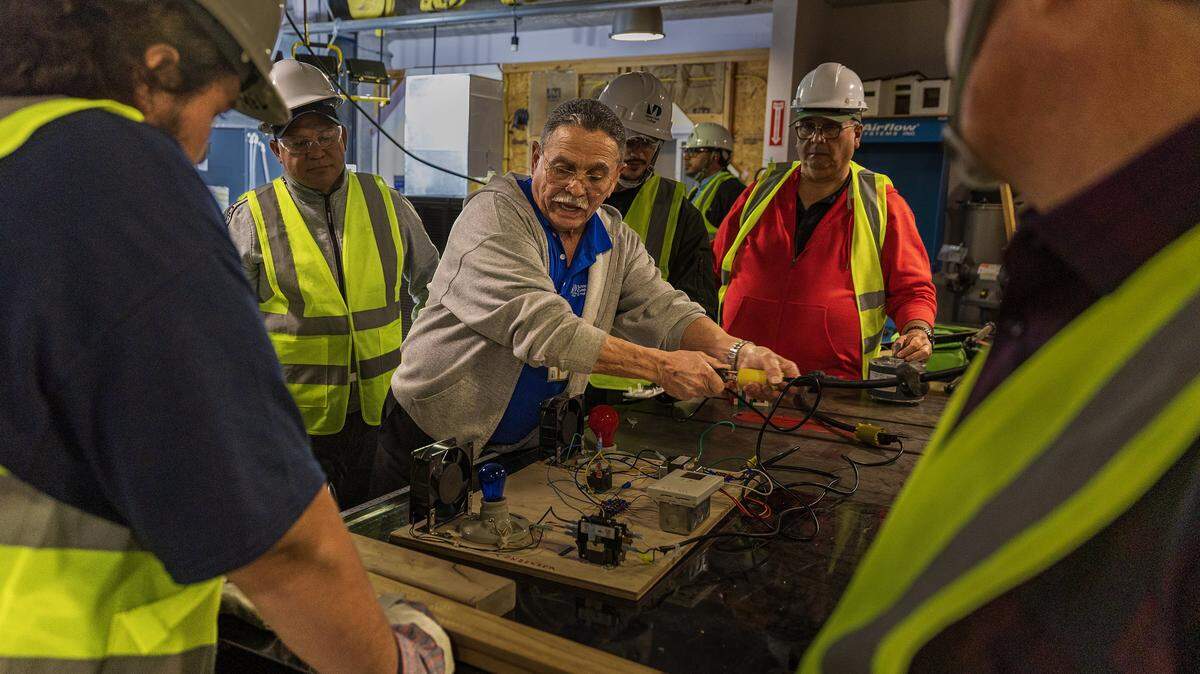 Instructor Omar Silva explains to students the way a thermostat functions in an AC system, during a nHVAC/R Technician Certificate Program class, at Miami Dade College North Campus, in North Miami, on Thursday, February 05, 2026.