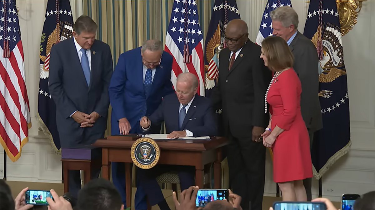 U.S. President Joe Biden signs the Inflation Reduction Act on Aug. 16, 2022. The law authorizes $369 billion in tax credits and grants to curb climate change.