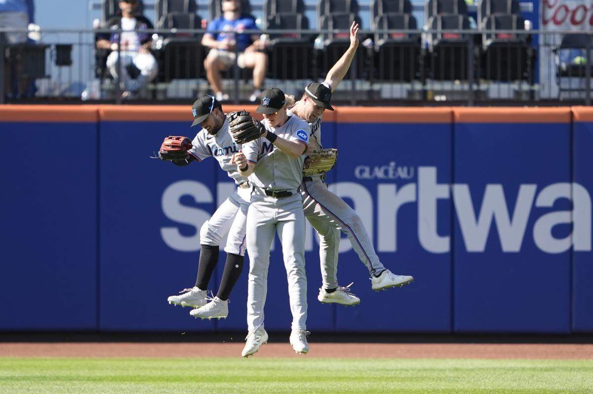 Los jugadores de los Marlins Heriberto Hernández (izq.), Jakob Marsee (centro) y Joey Weimer celebran tras la victoria 5-1 ante los Mets, el domingo en Nueva York.