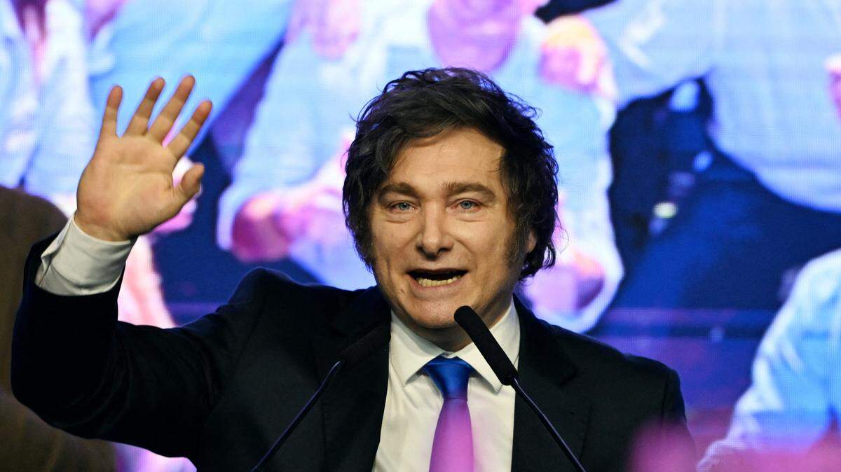 Argentina's President Javier Milei waves to supporters at the ruling party's La Libertad Avanza headquarters following the results of the national midterm legislative election in Buenos Aires on October 26, 2025. Argentina's budget-slashing leader Javier Milei pulled off a stunning win in Sunday's midterm elections, boosting the flagging reform agenda of the US-backed right-winger. (Photo by Luis ROBAYO / AFP) (Photo by LUIS ROBAYO/AFP via Getty Images)