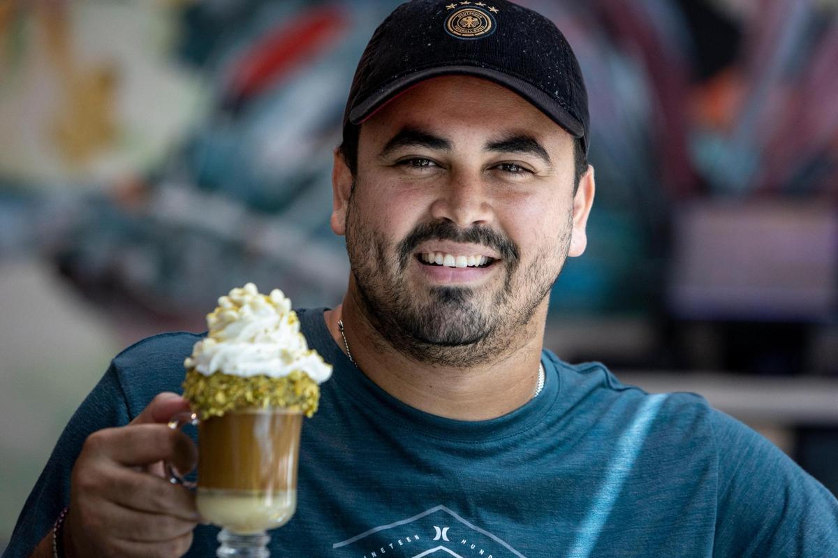 Coral Gables, FL- March 31 2023 - Jan Karlo Ruiz Ortiz, owner of the Bistro Café with a Pistacho Latte at the Bistro Café in Coral Gables. Bistro Cafe, 4155 Laguna Street, Coral Gables.