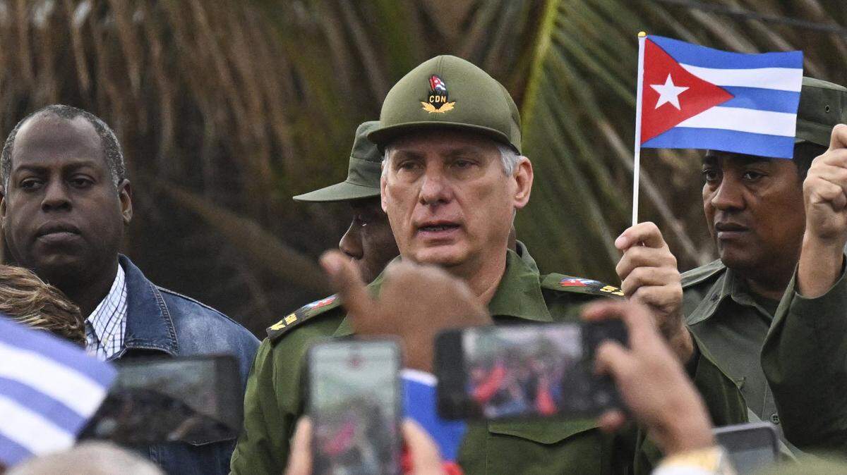 Cuba's President Miguel Diaz-Canel (C) takes part in the "Anti-Imperialist" protest in front of the US Embassy against the US incursion in Venezuela, where 32 Cuban soldiers lost their lives, in Havana on January 16, 2026. The capture by US forces of Venezuelan leader Nicolas Maduro on January 3, 2026, and the killing in the operation of 32 Cubans assigned to protect him represent a major blow for the island's revered intelligence services, experts say. (Photo by YAMIL LAGE / POOL / AFP via Getty Images)