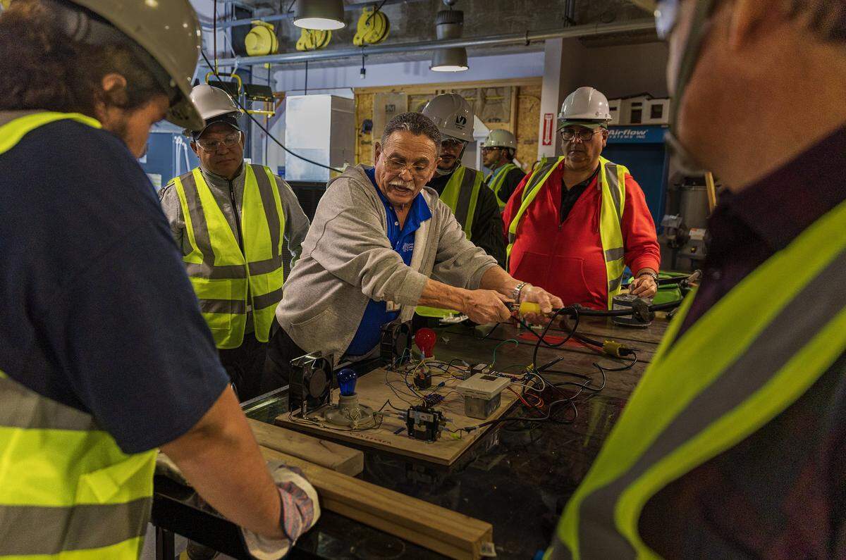 Instructor Omar Silva explains to students the way a thermostat functions in an AC system, during a nHVAC/R Technician Certificate Program class, at Miami Dade College North Campus, in North Miami, on Thursday, February 05, 2026.