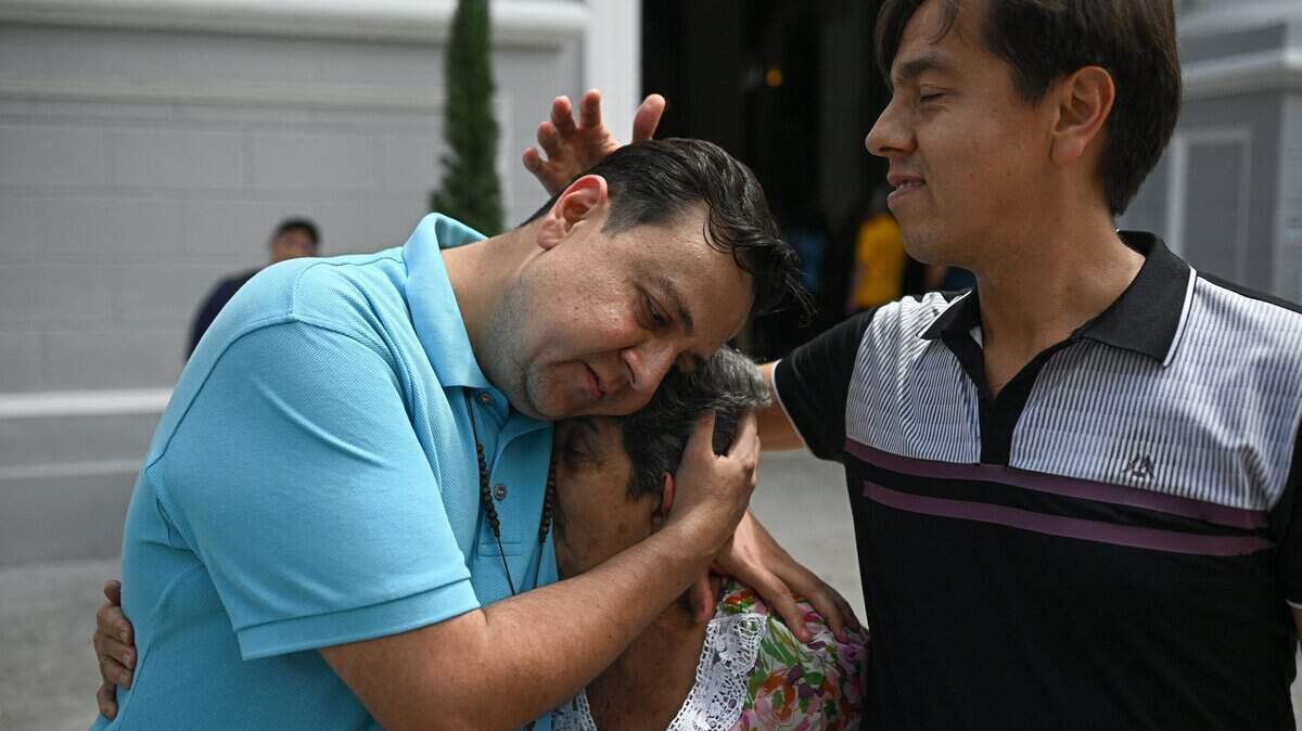 Human rights activist Javier Tarazona (L) celebrates with his brother Jose Rafael Tarazona (R) and his mother Teresa de Jesus Sanchez after his release from prison at La Candelaria church in Caracas on February 1, 2026. Renowned Venezuelan human rights activist Javier Tarazona was freed on February 1st after more than four years in prison on charges including terrorism and treason, his brother told AFP. (Photo by Federico PARRA / AFP via Getty Images)