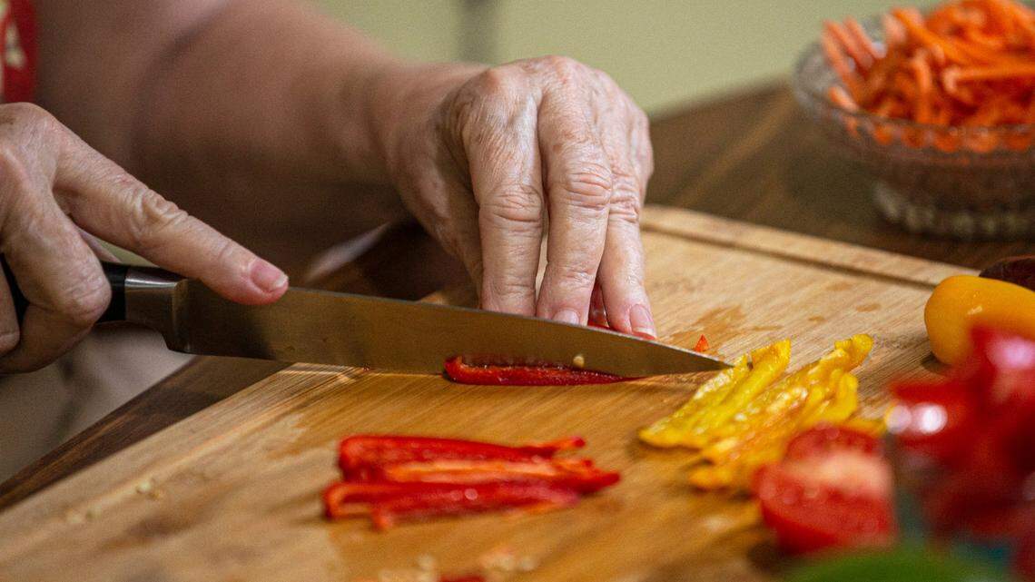 Susan Neuman, a Miami public relations professional who has diabetes and has adopted a vegan diet to help control it, cuts up veggies in her home kitchen in 2020.