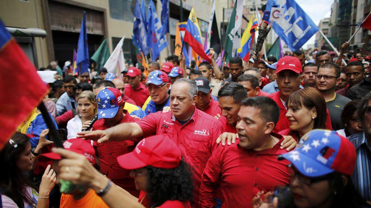 Diosdado Cabello, center, surrounded by bodyguards and supporters during an 'anti-imperialist march' on Aug. 14, 2017.