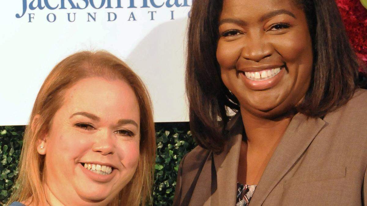 Charmaine Gatlin (right) posing with the CEO of the Jackson Health Foundation, Flavia Llizo.