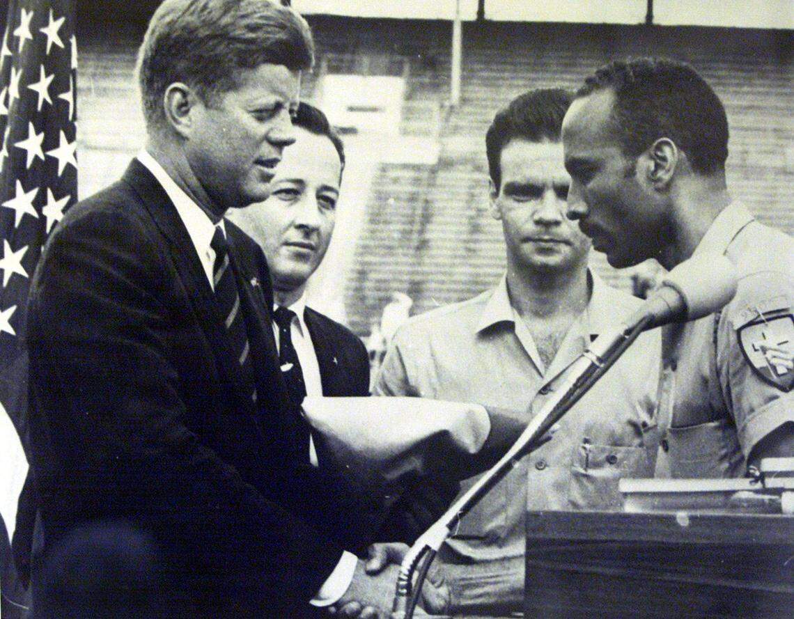 Gen. Erneido Oliva, who was second in command during the Bay of Pigs invasion, hands President John F. Kennedy the Brigade flag during a 1962 Miami visit.