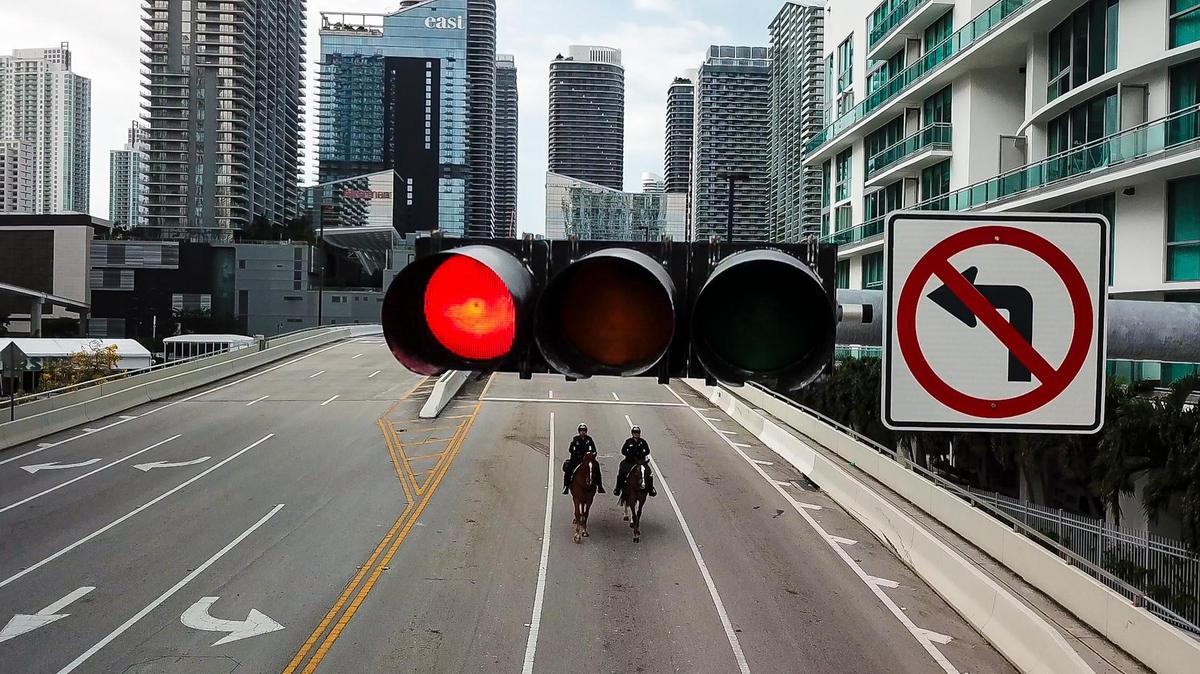 City of Miami Officers Loisel Cruz, left, and Ruben Gonzalez make their way toward downtown Miami mounted on their horses Ike, left, and Miss Miami, right, on Friday, April 17, 2020.